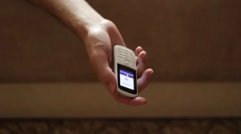 Calling telephone in a hanging insensible hand Vidéo 66757025