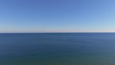 Calm aerial drone view of endless blue sea under clear sky Stock Footage 321966547