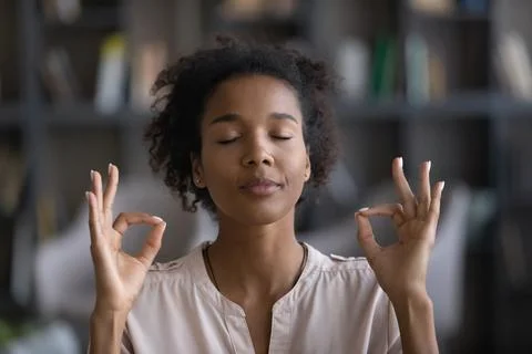 Calm African American woman meditate breathing fresh air Stock Photos