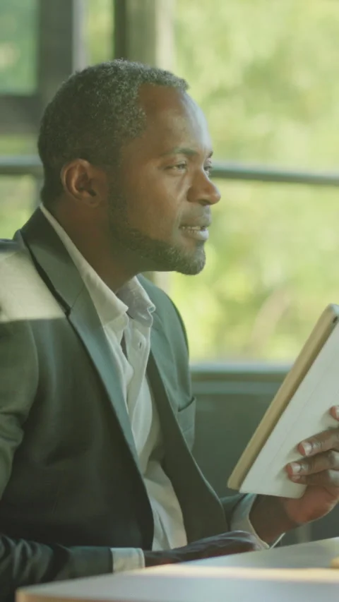 Calm analyst strategizes amid soft sunlight, Focused consultant examines notes Stock Footage 330038200