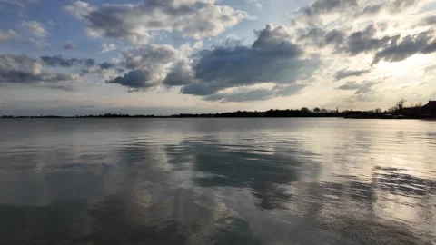 A calm and clear lake surface, sunset over the lake. Stock Footage 317634166