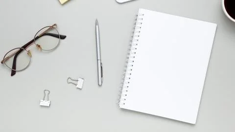 Calm and focused workspace featuring coffee cup, glasses, and notebook in min Stock-Fotos