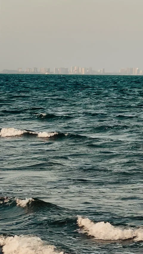 Calm and Gentle Waves Rolling on the Serene Ocean at Dusk Under a Softly Colored Stock Footage 301688075