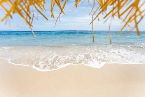 Calm and relaxing empty beach scene, blue sky and white sand. Stock Photos