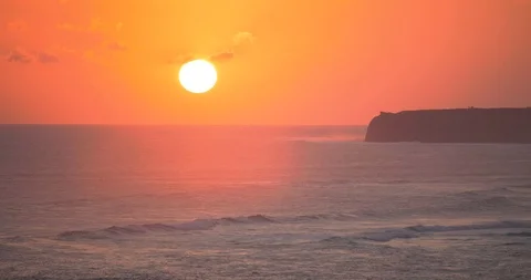 Calm and relaxing view of sun set below horizon and slow moving waves, Indonesia Stock Footage 113779516