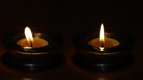 The calm and restless flame of two candles next to each other Stock Footage 230326920