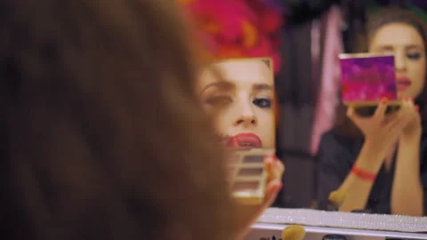 The calm and self-assured dancer appearance creating an evening makeup indoor Video stock 220469792