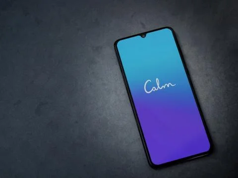 Calm app launch screen with logo on the display of a black mobile smartphone  Stock Photos