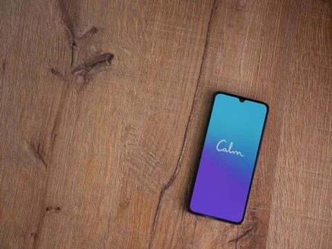 Calm app launch screen with logo on the display of a black mobile smartphone  Stock Photos