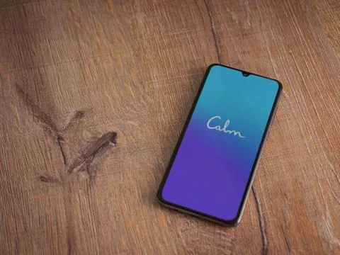 Calm app launch screen with logo on the display of a black mobile smartphone  Stock Photos