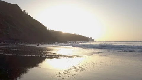 Calm atlantic ocean waves slowly covering wide beach with volcanic sand during Video stock 123042756