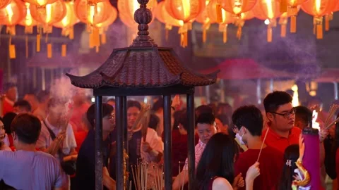 Calm atmosphere as devotees offer incense at night. Stock Footage 318102368