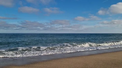 Calm autumn waves gently hitting the sandy beach coastline Stock Footage 321180966