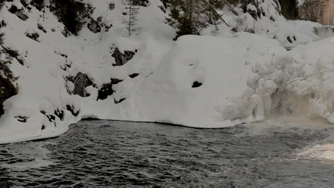 Calm bay of winter river with high snow banks and waterfalls Video stock 109203907