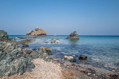 Calm beach with rocks Stock Photos
