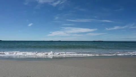 Calm beach scene with gentle waves and clear sky near Norwegian shoreline i.. Stock Footage 340198775