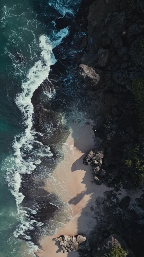 Calm beach scene. Serene harbor with frothy waves near emerald coastlines Stock Footage 346799564