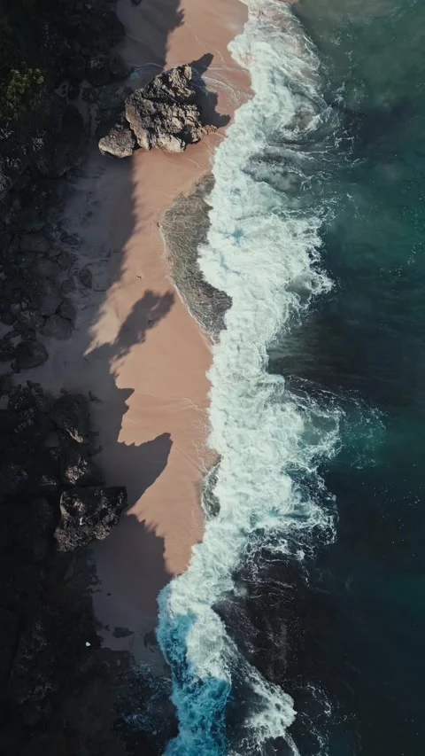 Calm beach scene. Serene harbor with frothy waves near emerald coastlines Stock Footage 346799592