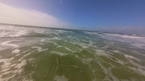 Calm beach waves roll in with soft white foam. After the storm Stock Footage 345061155