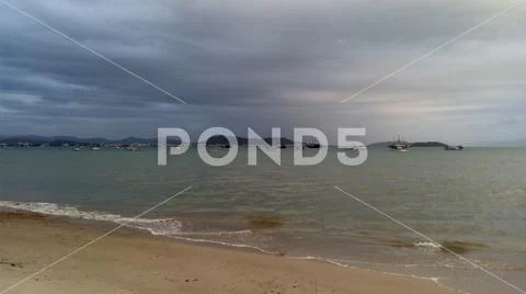 Calm beach where some boats are moored Stock Photos