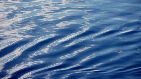 Calm Blue Ocean Water Surface with Gentle Ripples and Sky Reflections. Stock Footage 340189455