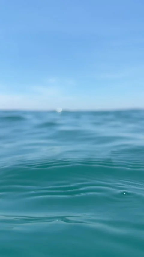 Calm blue sea surface with gentle waves and a clear horizon under a bright sky. Stock Footage 338001832