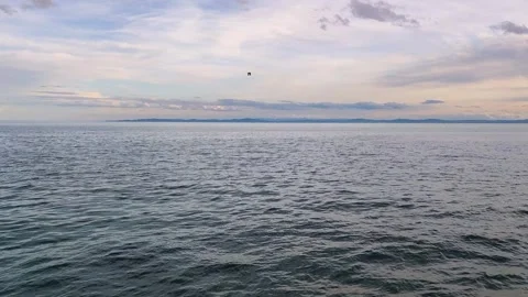 Calm Blue Sea Surface with Soft Clouds at Sunset, Peaceful Seascape Background Stock Footage 329593837