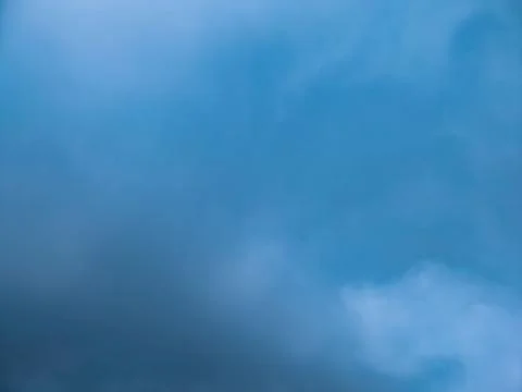 Calm blue sky texture with soft clouds, atmospheric haze and copy space 库存照片