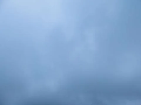 Calm blue sky texture with soft clouds, atmospheric haze and copy space Stockfoto's