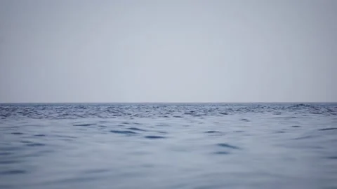 Calm blue water surface with the soft reflection. Footage. Closeup slowmotion Stockbeeldmateriaal 141735609
