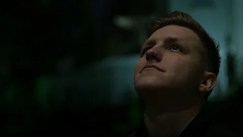 Calm boy looking up on the low light street Stock Footage 106316523