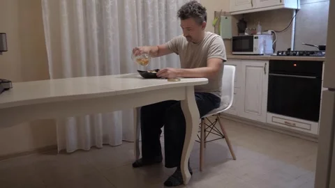 Calm breakfast routine at kitchen table Stock Footage 337799843