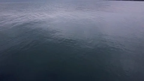 Calm Caspian sea surface with gentle ripples reflecting the overcast sky above Stock Footage 336246994