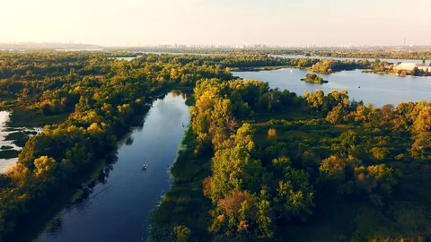 The calm clean river flows between green trees. Aerial view Video stock 128398508