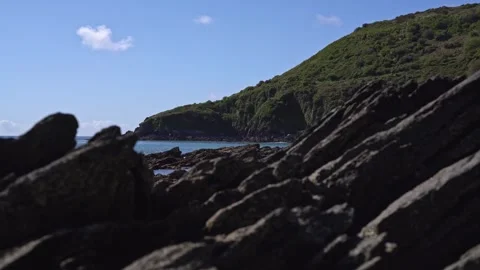 Calm Coastal View Through Rocks with Waves and Birdsong, Portnadler Bay Cornwall Stock Footage 332744723