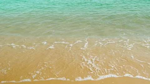 Calm coastal waves of a sandy beach with turquoise sea water. Stock Footage 326666964