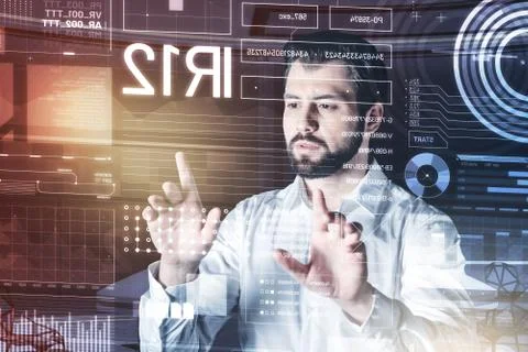 Calm computer programmer looking concentrated while changing settings Stock Photos