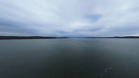 Calm current with distant urban silhouette Stock Footage 320849332