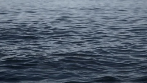 Calm dark ocean waves gently rippling across the deep sea Stock Footage 337409065
