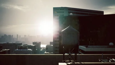 Calm dawn bathes city rooftops with gentle hues and tranquil hazy air Stock Footage 339802367