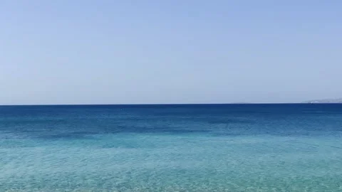 Calm deep blue ocean with blue sky Stock Footage