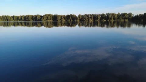 Calm Drone Flight Over Sunny Lake in Summer Stock Footage 328534813