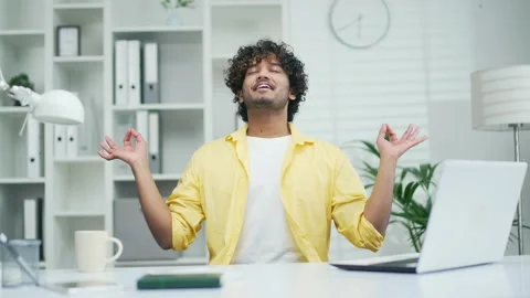 A calm employee worker practices yoga at the workplace in the office Happy  Stock Footage 235504877