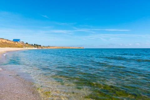 Calm empty sea and sandy shore Stock Photos