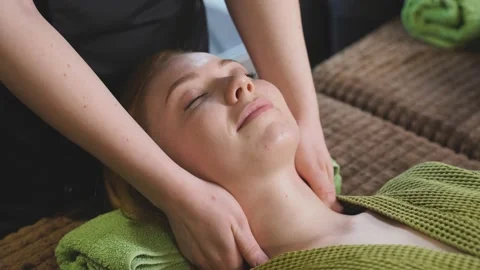 Calm female lie on bed in spa salon, getting massage on neck and chest. Stock Footage 150616640