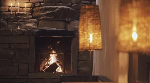 Calm fireplace with warm light at night with candle and wine Stock Footage 61870458