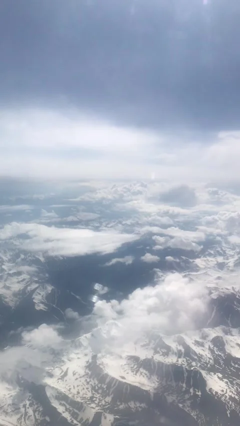A calm flight above the clouds and mountains Stock Footage 338041421