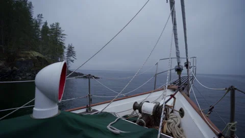 Calm foggy morning looking at shore from sailboat. Stock Footage