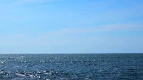 Calm, gentle blue ocean waves and blue sky - slow motion Stock Footage 152345286