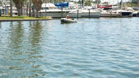 Calm Green Water as a small rubber  raft boat passes by right to left . Editoria Stock Footage 312708001
